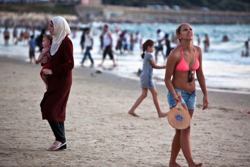 Israeli Jewish girl and Palestinian Arab woman at the Tel-Aviv beach, August 2012.
